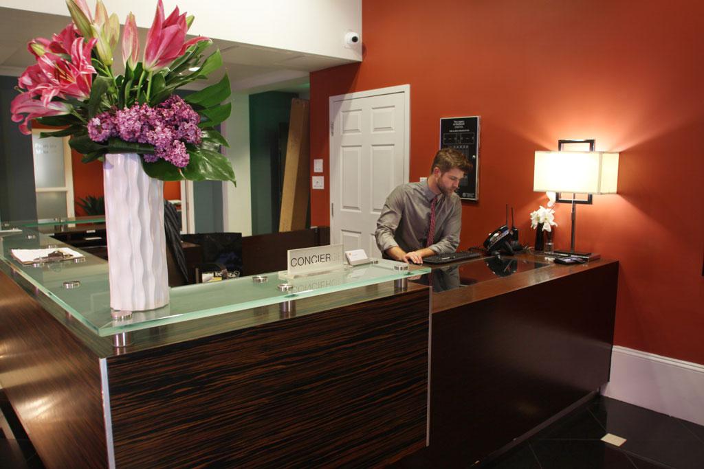 Concierge desk at The Legacy at Westwood, offering personalized guest services as part of Los Angeles Luxury Furnished Housing amenities.